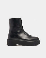side view of platform ankle boots in black leather