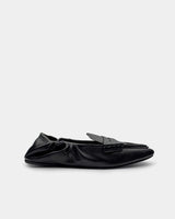 Side view of women’s black loafers in leather