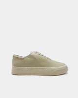 Side view of platform sneakers in ivory leather