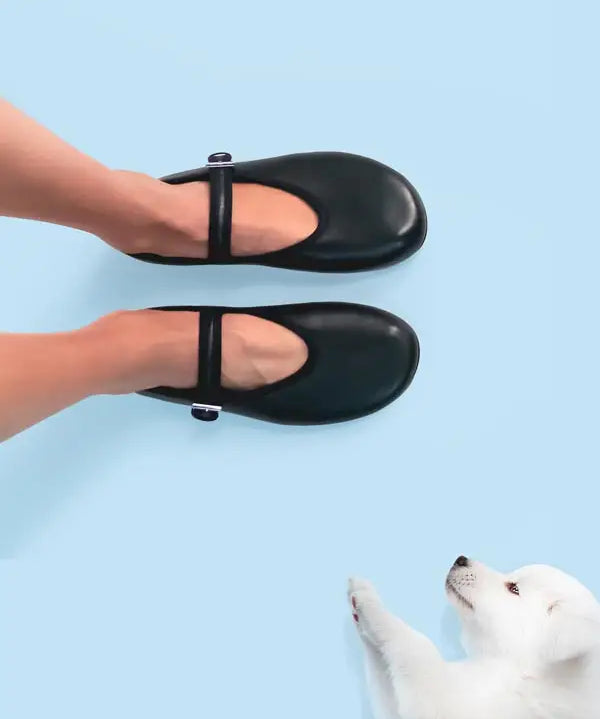 Model styling black ballet flats in soft leather
