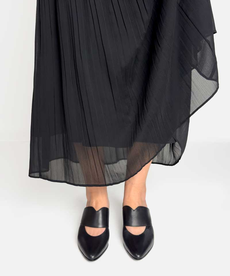 Heeled mules in black leather pair with black dress