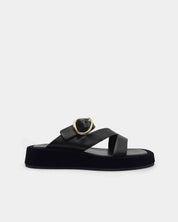 Black platform sandal with a gold buckle