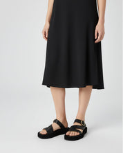 Woman wearing black platform sandals in suede leather