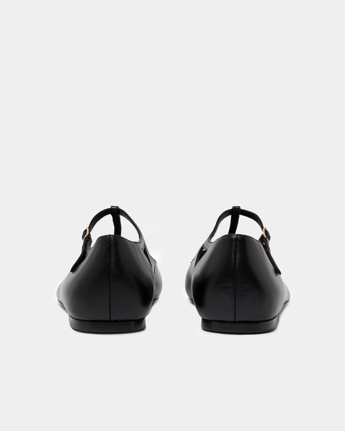Women's black flats in leather with t strap adjustable design