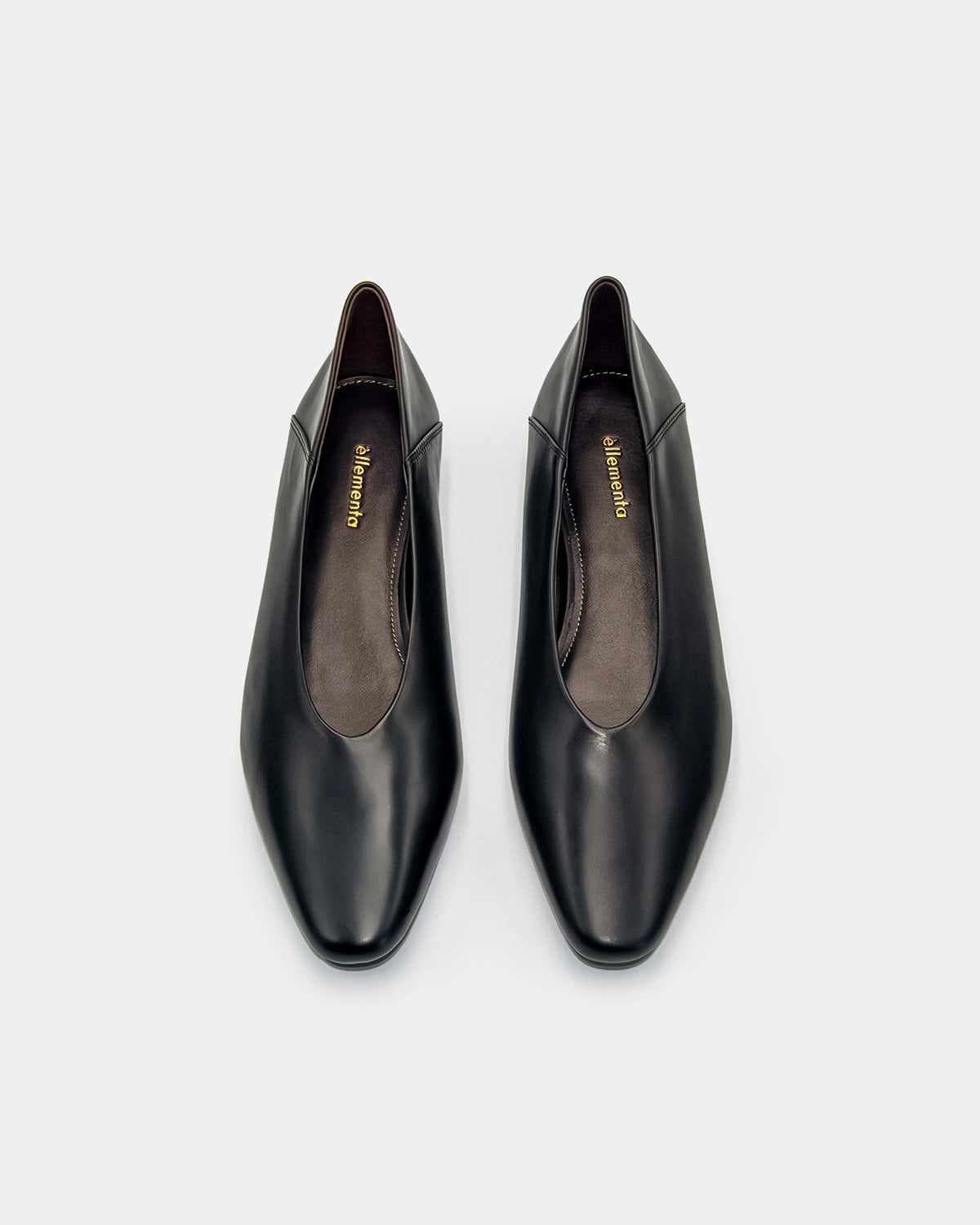 Pair of black leather shoes on a white background