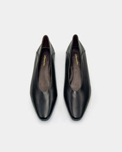 Pair of black leather shoes on a white background