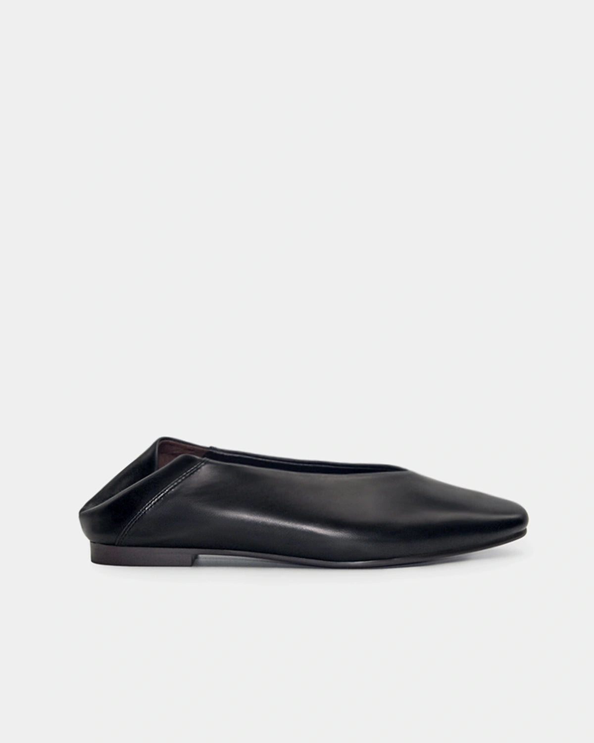 Black flat shoe on a light gray background
