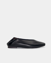 Black flat shoe on a light gray background