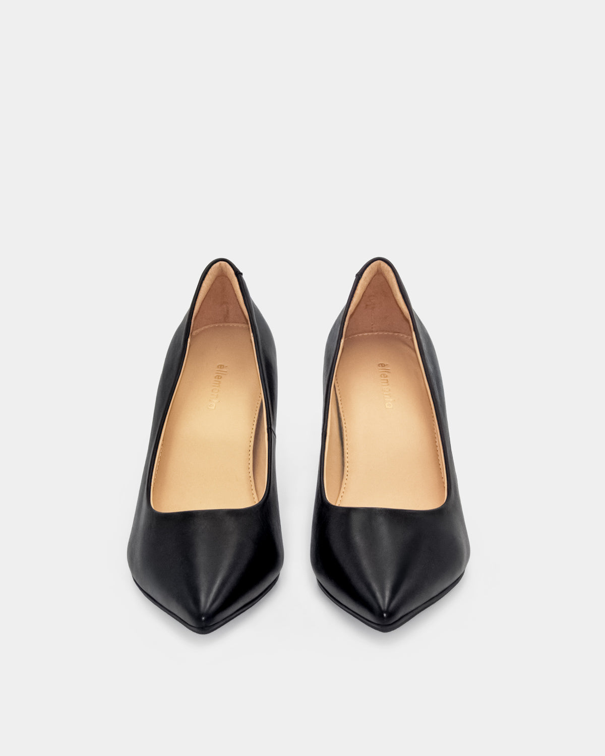 A pair of black leather pointed-toe pumps with a light tan interior lining, shown from a top-down view on a light gray background.