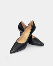 A pair of black leather pointed-toe pumps with heels, displayed on a light gray background.