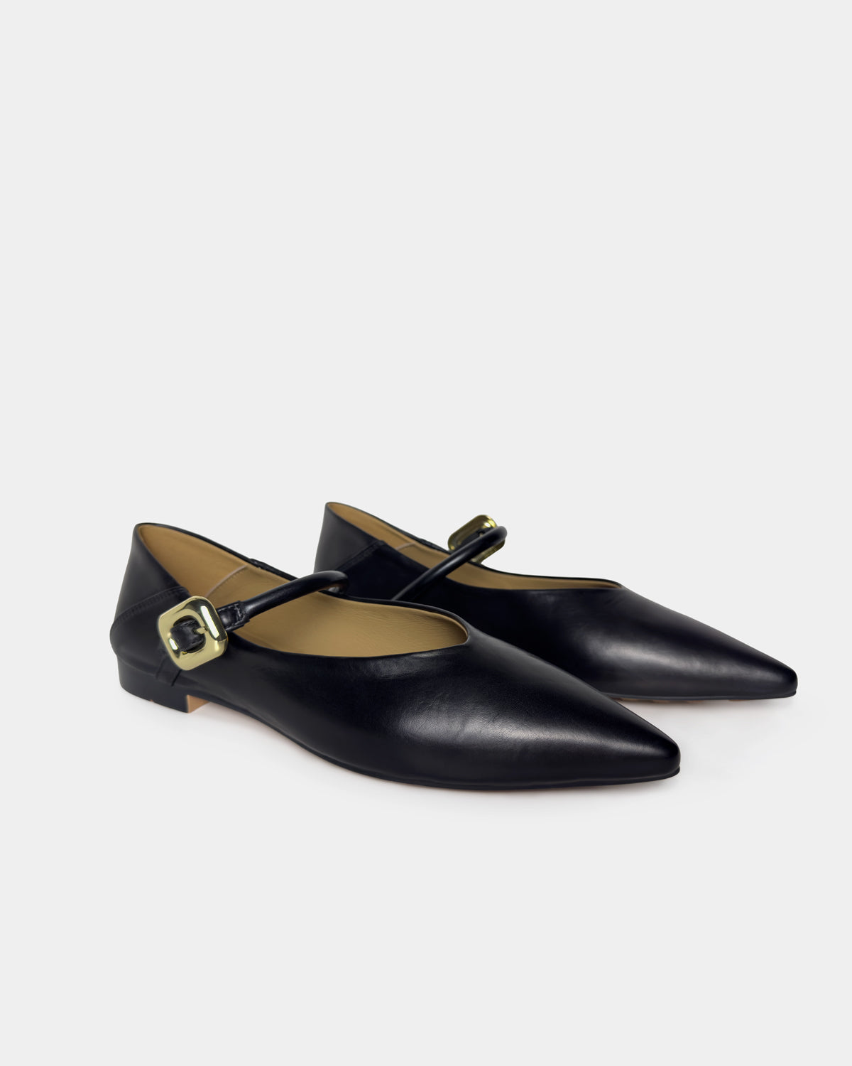 A pair of black leather pointed-toe Mary Jane flats with gold-tone buckle straps, displayed on a light gray background.