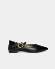 A single black leather flat shoe with a pointed toe and a gold-tone buckle strap, shown in profile against a light gray background.