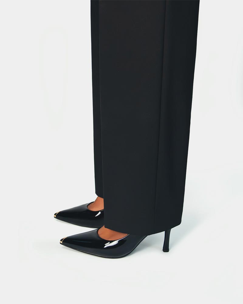 Model styling black heels in patent leather