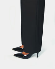 Model styling black heels in patent leather