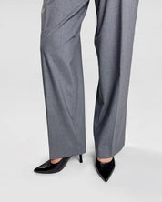 Gray pants worn with black high-heeled shoes on a white background
