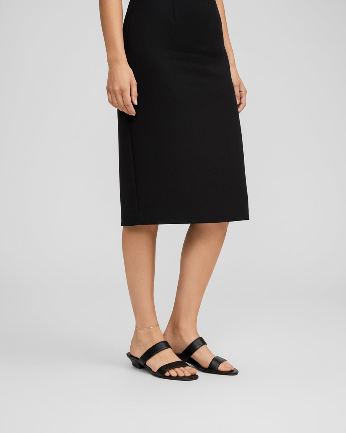 Woman wearing black leather heeled strap sandals Australia