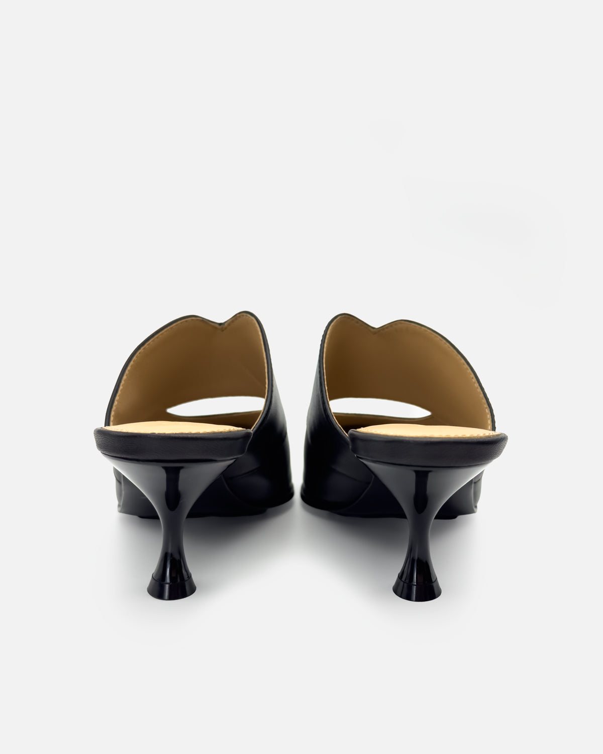 Back view showing kitten heels of black mules