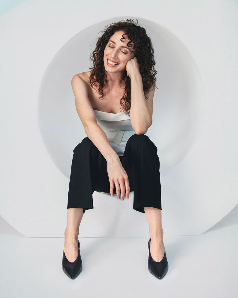 woman wearing black kitten heels in leather comfortable for work and events.