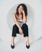 woman wearing black kitten heels in leather comfortable for work and events.