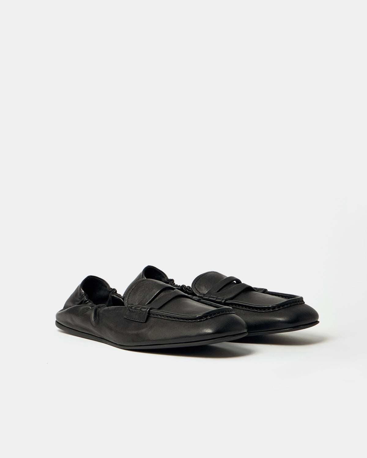 Pair of black loafers on a white background