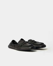Pair of black loafers on a white background