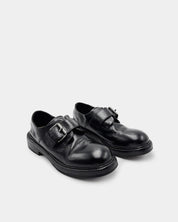 Pair of black leather monk loafers with adjustable buckles 