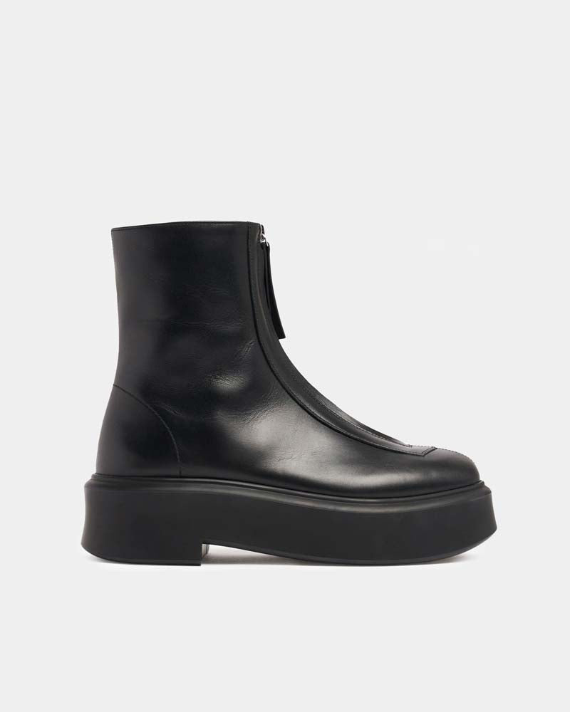 side view of platform ankle boots in black leather