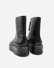 Women's platform boots in black leather with supportive sole 