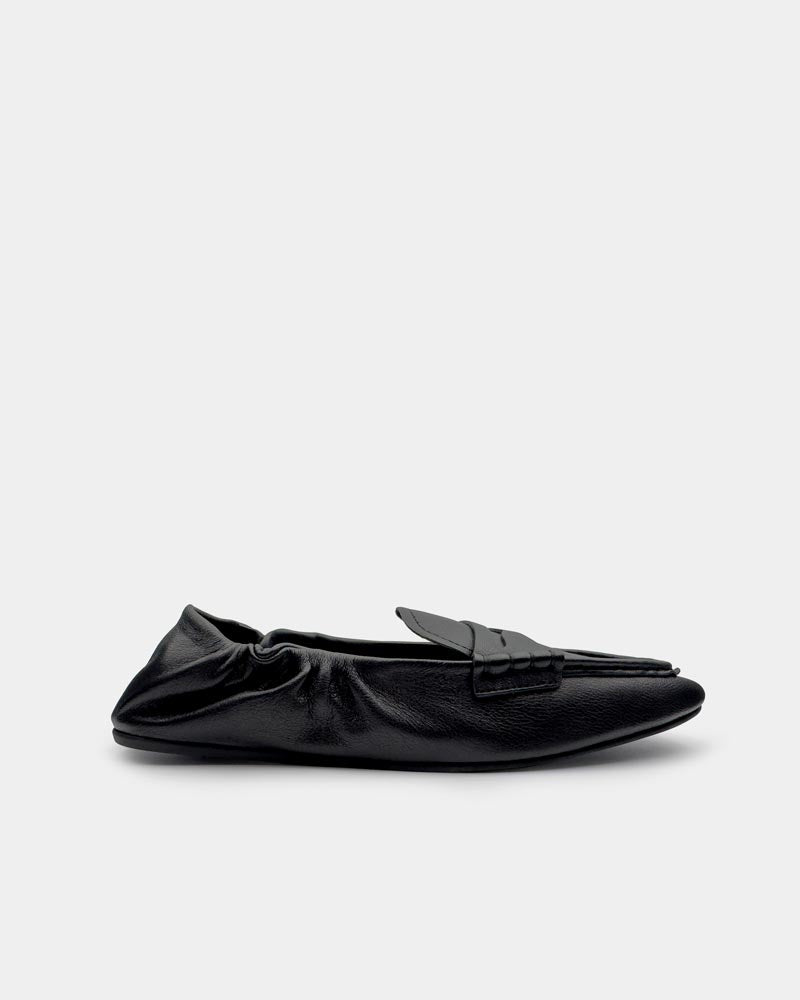 Side view of women’s black leather slip-on loafers
