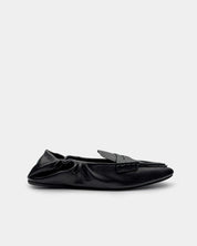 Side view of women’s black leather slip-on loafers