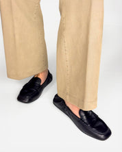 Model styling women's black loafers in soft leather