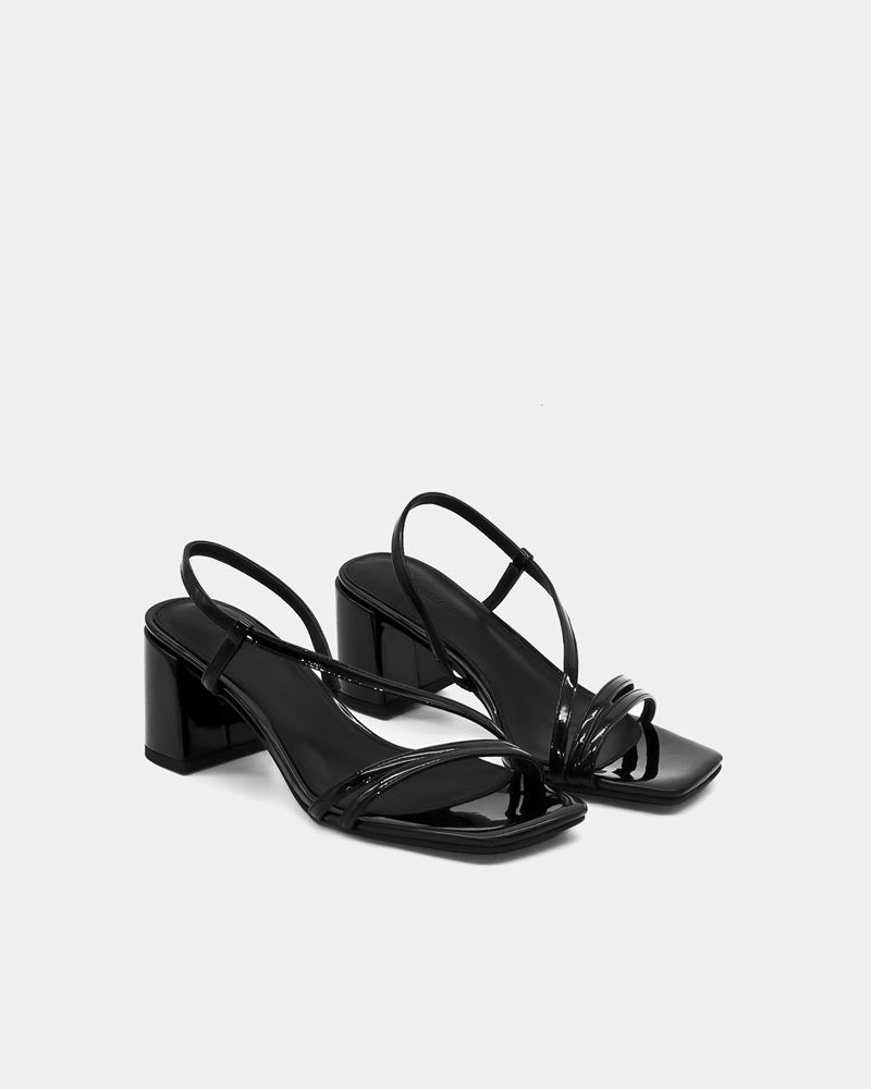 Pair of black strappy sandals with block heel and cushioned leather footbed