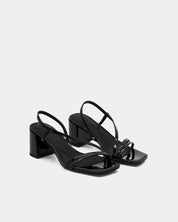 Pair of black strappy sandals with block heel and cushioned leather footbed