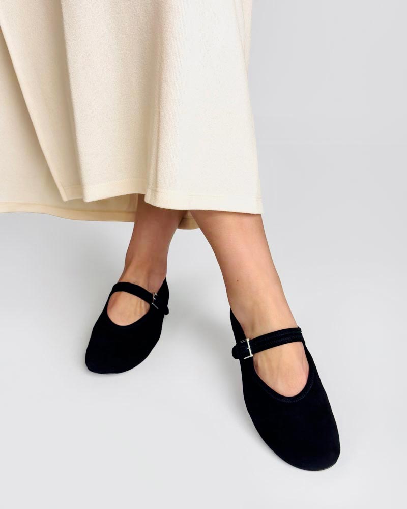Model wearing black suede ballet flats 