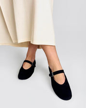 Model wearing black suede ballet flats 