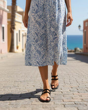 Woman wearing black slides with comfort cushioned footbed