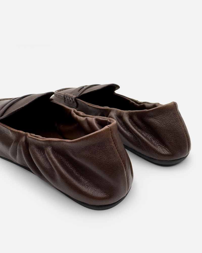 Close-up of elasticated back on brown loafers for women