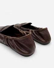 Close-up of elasticated back on brown loafers for women