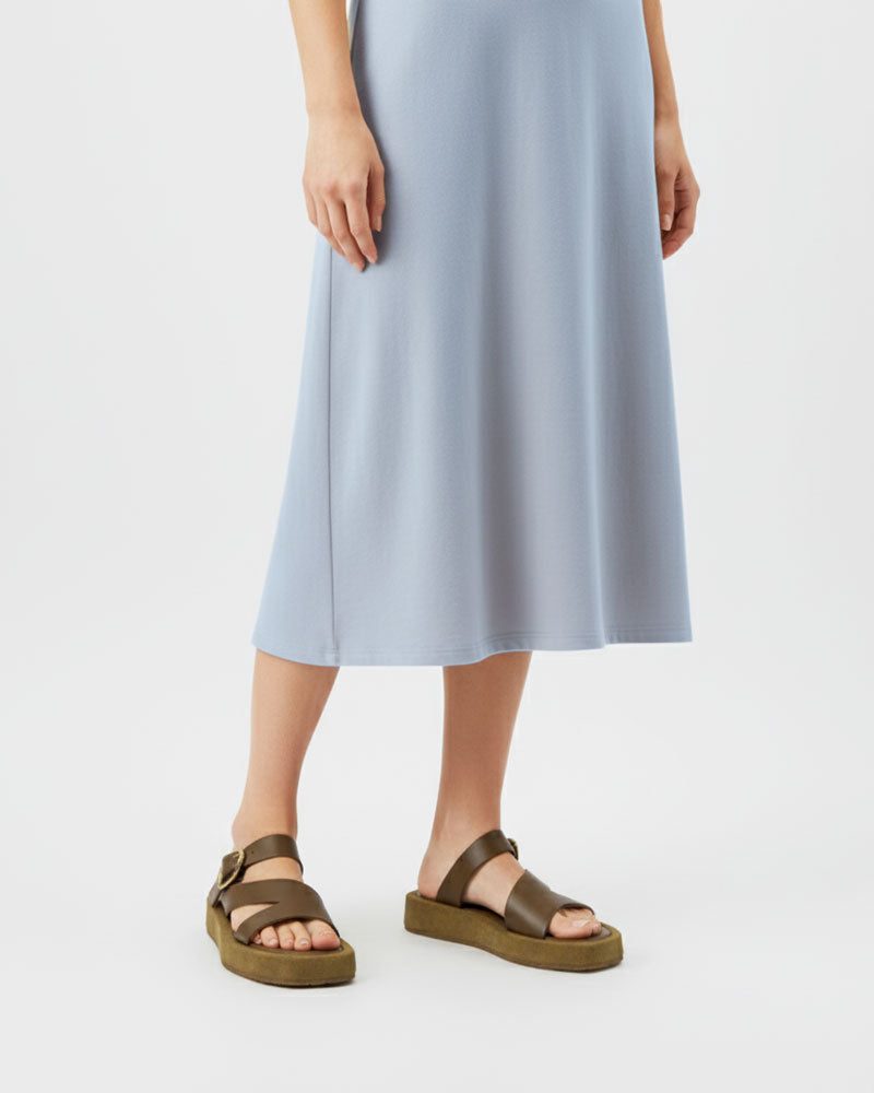 Woman wearing brown platform sandals with straps in suede leather