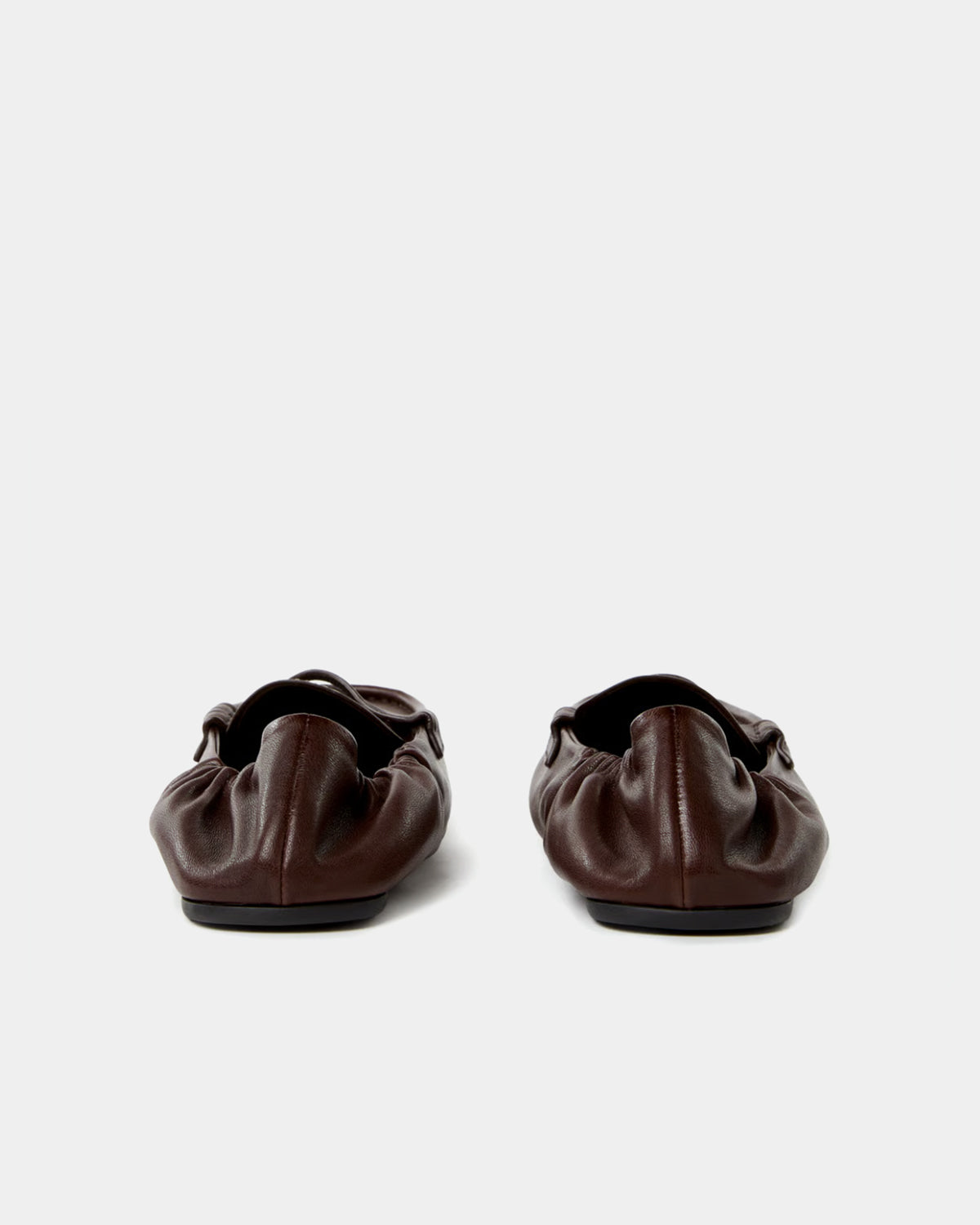 Pair of dark brown leather shoes on a white background