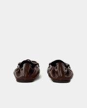 Pair of dark brown leather shoes on a white background