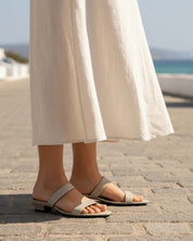 Woman wearing beige leather heeled strap sandals Australia