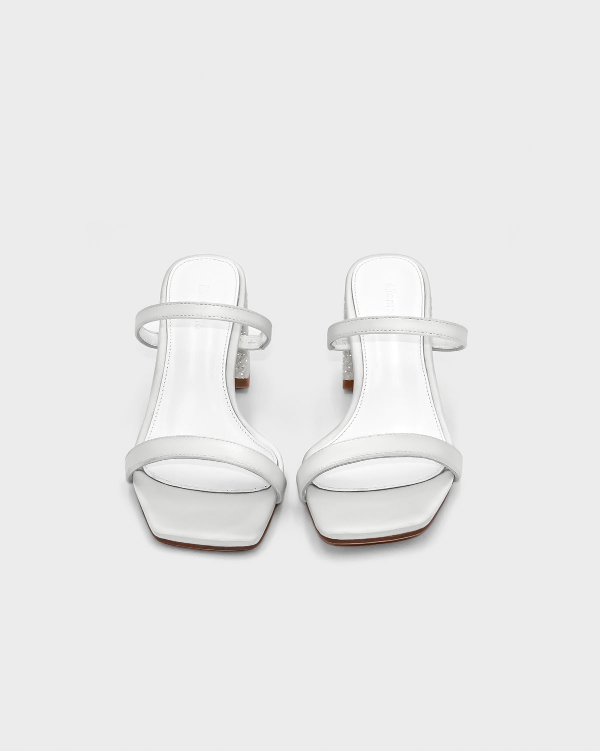 White heeled sandals with leather straps and padded footbed