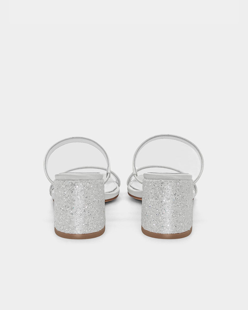 Pair of white sandals with glitter block heel and adjustable straps