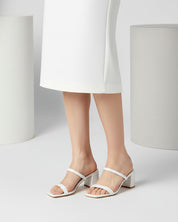 Woman wearing white block heel slide sandals Australia