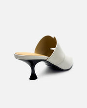 Side view of white mules with kitten heel