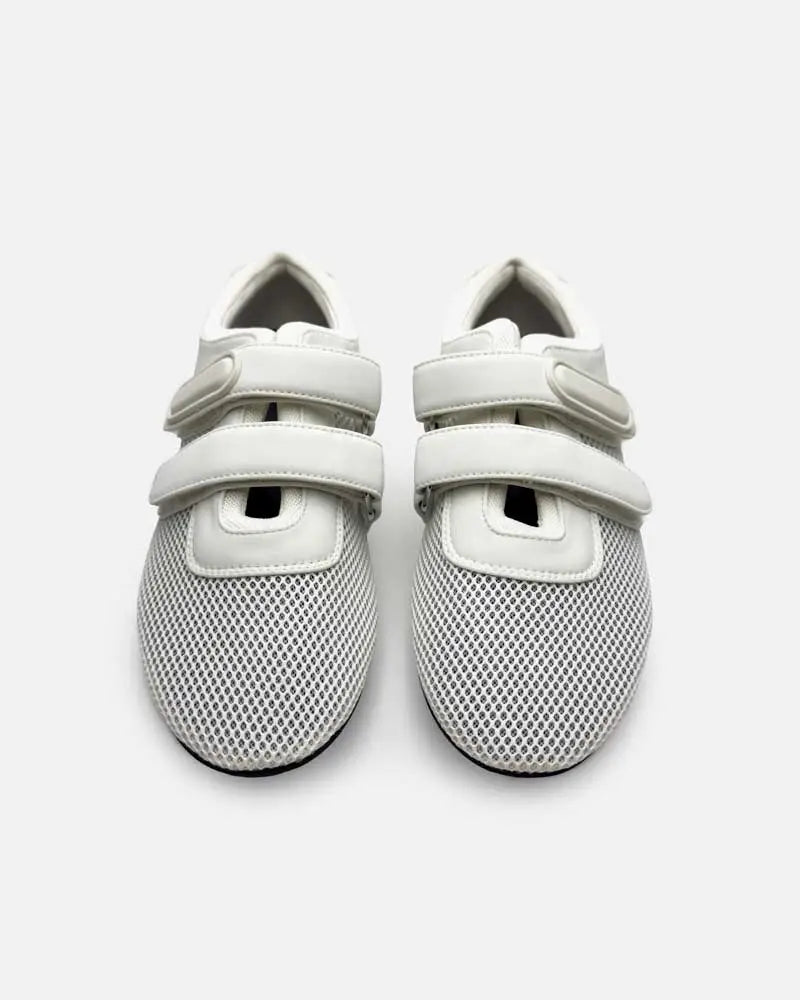 Pair of women's white sneakers with strap