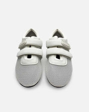 Pair of women's white sneakers with strap