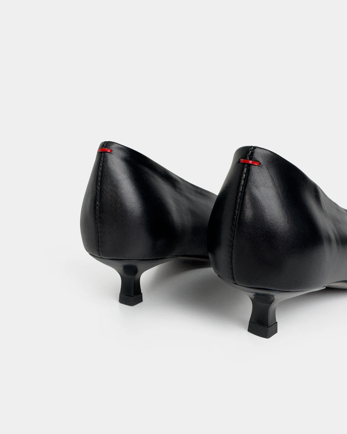 black kitten heel counter details on light gray background 