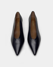 A pair of black leather pointed-toe pumps with a low block heel, shown from a top-down view on a light gray background.